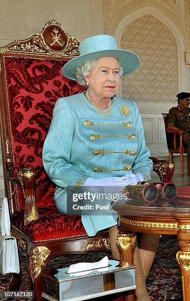 Queen Elizabeth II sits as she watches an equestrian event and horse racing, at the Royal Horse Racing Club ON nOVEMBER 27, 2010 in Seeb Oman. The...