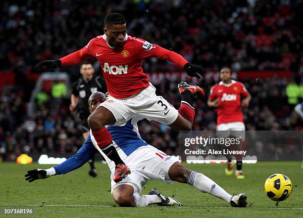 Patrice Evra of Manchester United hurdles the challenge of El Hadji Diouf of Blackburn Rovers during the Barclays Premier League match between...