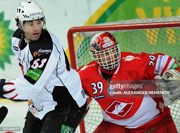 Chech Jaromor Jagr of Avangard Omsk attacks the net of an other Czech hockey legend Dominik Hasek of Spartak Moscow during their Russian open...