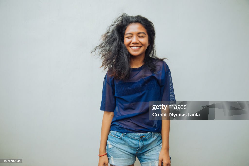 Portrait of a young Indonesian woman smiling.