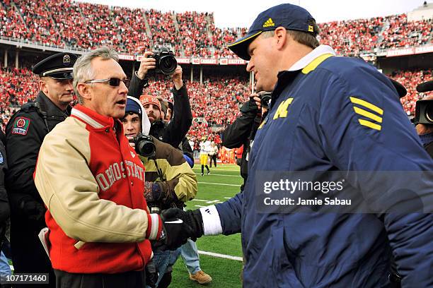Head Coach Jim Tressel of the Ohio State Buckeyes shakes hands with Head Coach Rich Rodriguez after the Buckeyes defeated the Wolverines 37-7 at Ohio...