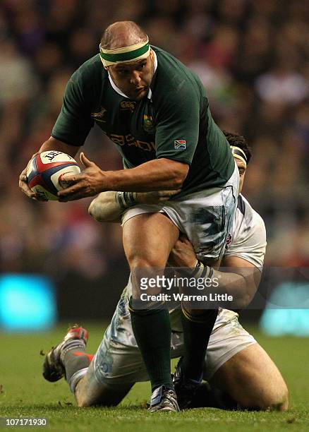 Van der Linde of South Africa is tackled as he runs with the ball during the Investec Challenge match between England and South Africa at Twickenham...