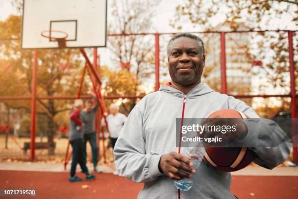 senior sport - basketball - mature men playing basketball stock pictures, royalty-free photos & images