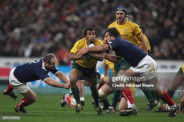 Will Genia of Australia cuts between Julien Pierre and William Servat during the Test match between France and the Australian Wallabies at the Stade...