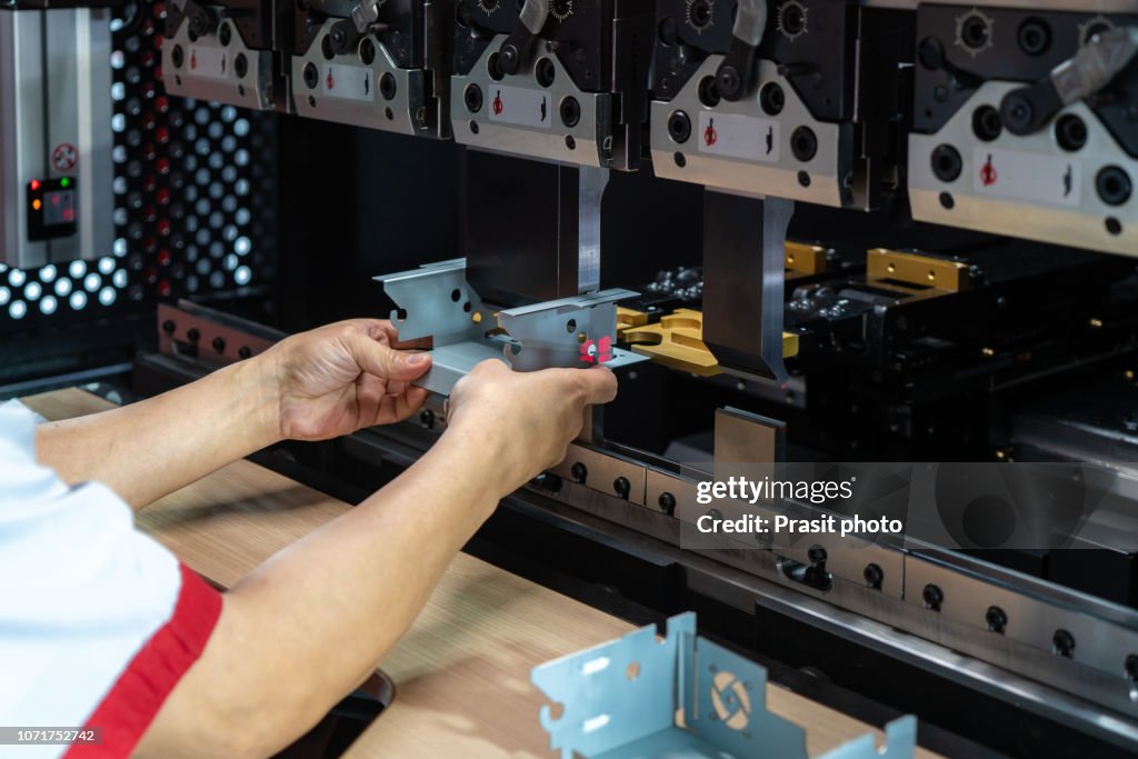 Worker at manufacture workshop operating cidan folding machine