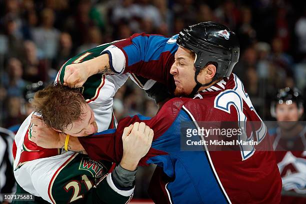 Chris Stewart of the Colorado Avalanche fights with Kyle Brodziak of the Minnesota Wild in the second period at the Pepsi Center on November 27, 2010...