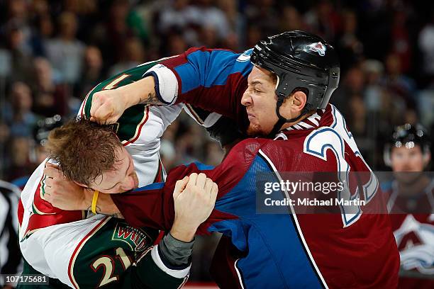 Chris Stewart of the Colorado Avalanche fights with Kyle Brodziak of the Minnesota Wild in the second period at the Pepsi Center on November 27, 2010...