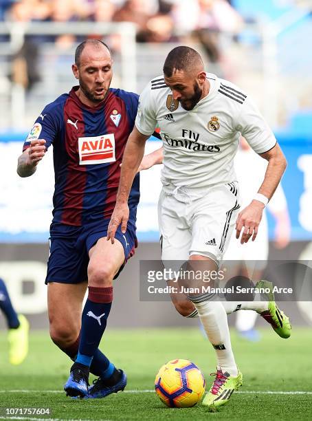 Karim Benzema of Real Madrid duels for the ball with Ivan Ramis of SD Eibar during the La Liga match between SD Eibar and Real Madrid CF at Ipurua...