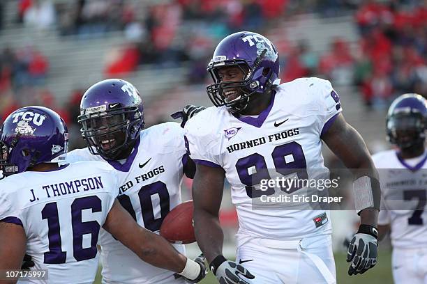 Braylon Broughton, Stansly Maponga and Jurell Thompson of the TCU Horned Frogs celebrate after a touchdown against the University of New Mexico Lobos...