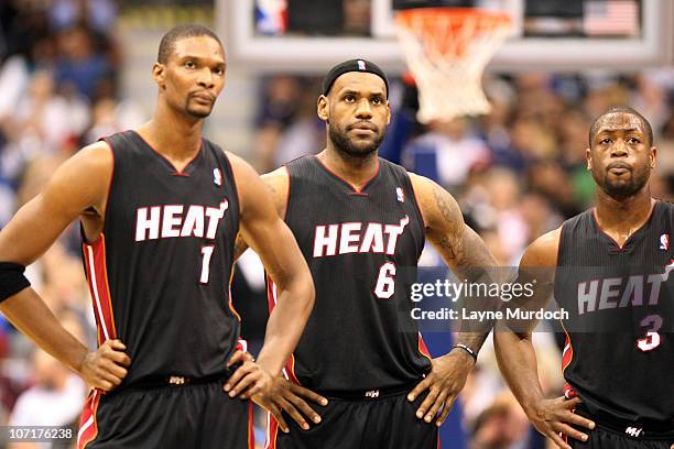 Chris Bosh, 2 and Dwyane Wade of the Miami Heat look on during their game against the Dallas Mavericks on November 27, 2010 at the American Airlines...