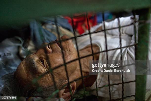 Years old Tam Wing Dik lays in his cage dwelling on November 27, 2010 in Hong Kong, China. Hong Kong's property prices having soared over the past...