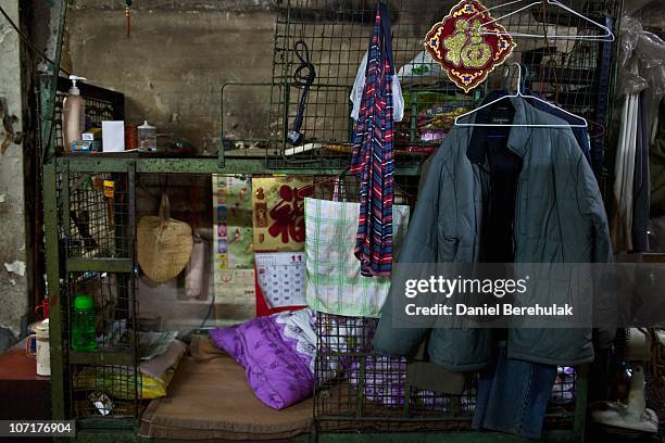 Clothes and valuables are seen on a cage dwelling on November 27, 2010 in Hong Kong, China. Hong Kong's property prices having soared over the past...