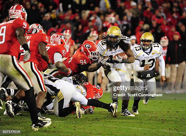 Anthony Allen of the Georgia Tech Yellow Jackets carries the ball against DeAngelo Tyson of the Georgia Bulldogs at Sanford Stadium on November 27,...