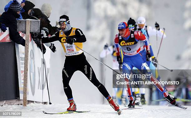 Russian Alexander Legkov , Swiss Dario Cologna and Sweden's Daniel Rickardsson compete in the men's 15km freestyle cross country of the skiing World...