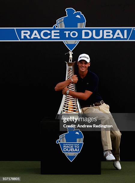 Martin Kaymer of Germany poses with the trophy after winning The Race To Dubai at the Dubai World Championship on the Earth Course, Jumeirah Golf...