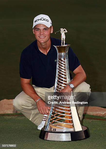Martin Kaymer of Germany poses with the trophy after winning The Race To Dubai at the Dubai World Championship on the Earth Course, Jumeirah Golf...