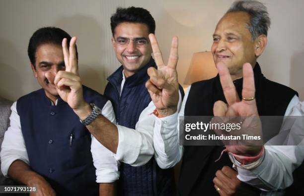 State Congress President Sachin Pilot and former CM Ashok Gehlot flash victory sign along with KC Venugopal during a press conference, on December...