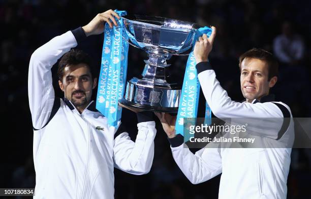 Daniel Nestor of Canada and Nenad Zimonjic of Serbia hold the trophy as they celebrate winning the men's doubles final match against Mahesh Bhupathi...