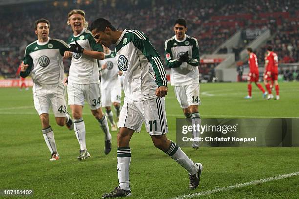 Cicero of Wolfsburg celebrates the first goal with Andrea Barzagli , Simon Kjaer of Wolfsburg and Tolga Cigerci during the Bundesliga match between...