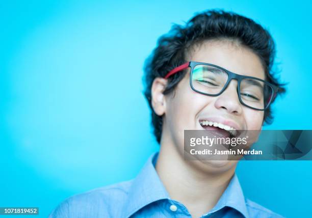 teenage boy laughing - boy portrait studio stock-fotos und bilder