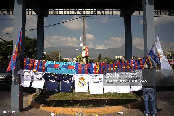 Salvadorean Manuel Gonzalez displays jerseys for sale of Barcelona Football Club and Real Madrid Football Club in San Salvador, on November 26, 2010....