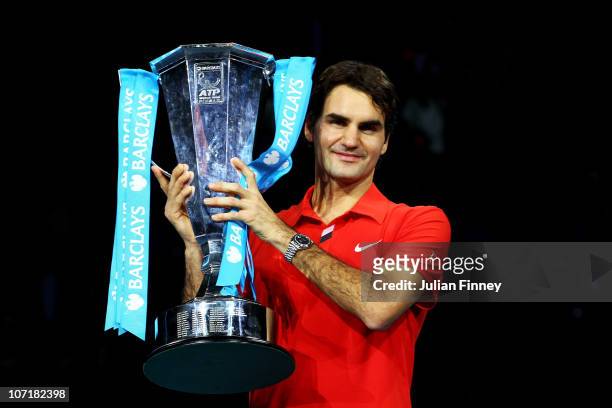Roger Federer of Switzerland poses with the trophy after defeating Rafael Nadal of Spain in their men's final match during the ATP World Tour Finals...
