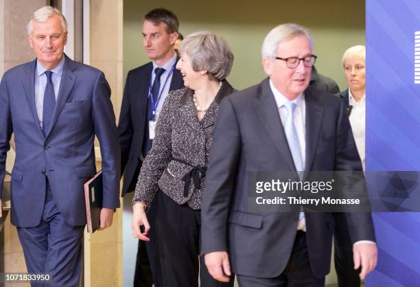 British Prime Minister Theresa May is looking at the European Chief Negotiator for the United Kingdom Exiting the European Union Michel Barnier while...