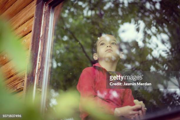 Little boy on window in cottage