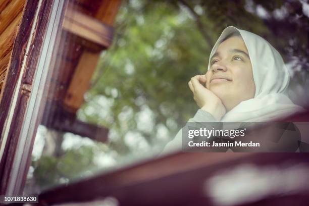 girl on window - cute arab girls stockfoto's en -beelden