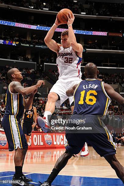 Blake Griffin of the Los Angeles Clippers pulls down a rebound between Raja Bell and Francisco Elson of the Utah Jazz at Staples Center on November...