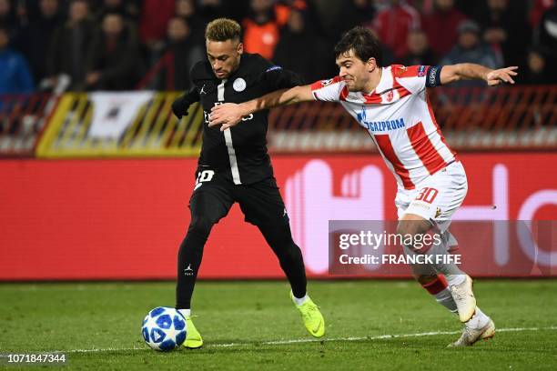 Paris Saint-Germain's Brazilian forward Neymar vies with Red Star Belgrade's Montenegrin defender Filip Stojkovic during the European Champions...