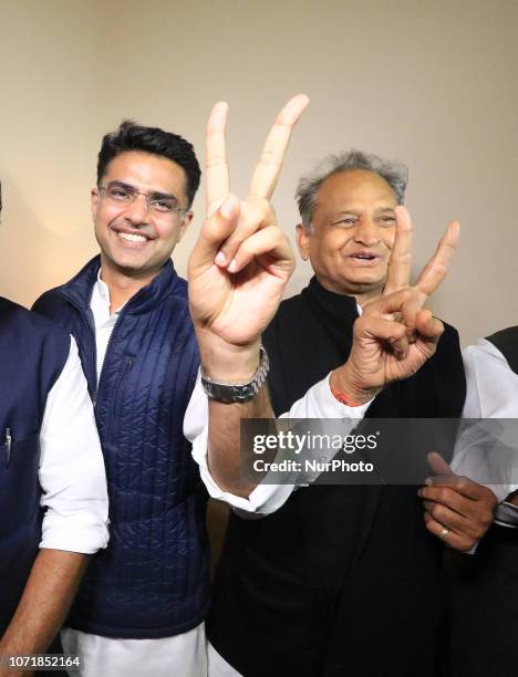 Congress leaders Ashok Gehlot and Sachin Pilot flash victory signs after the declaration of Rajasthan Assembly election result, in...