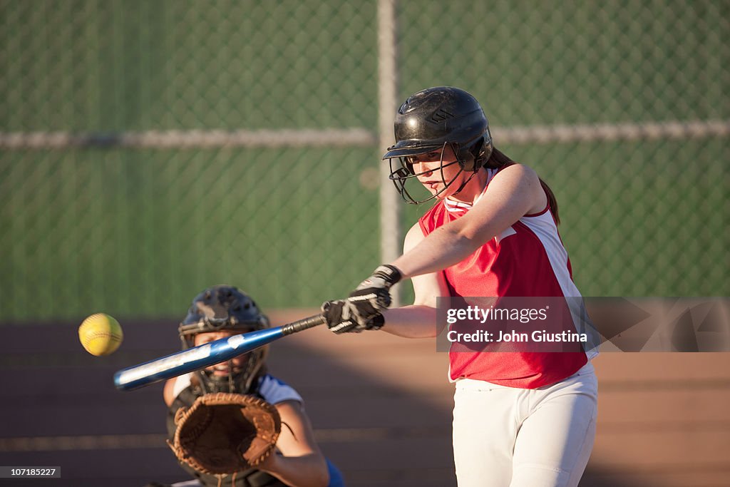 Girl's softball player batting.