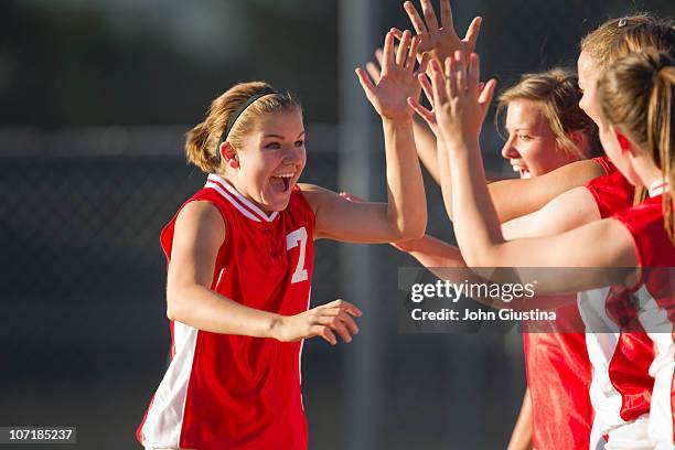 girl's softball players celebrating. - softball sport stock pictures, royalty-free photos & images