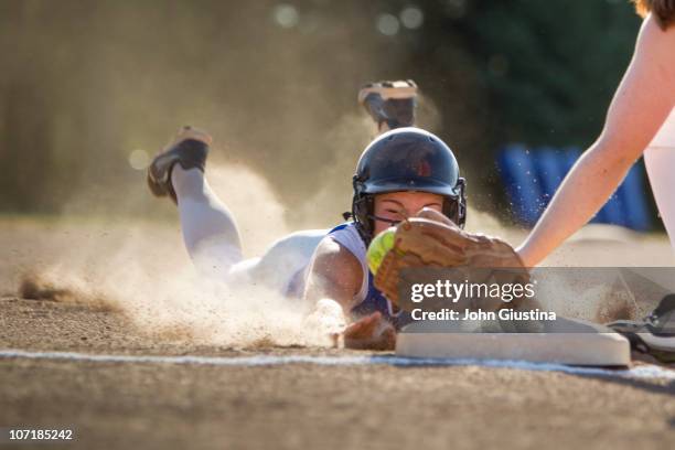 softball player slides head first. - softball sport imagens e fotografias de stock