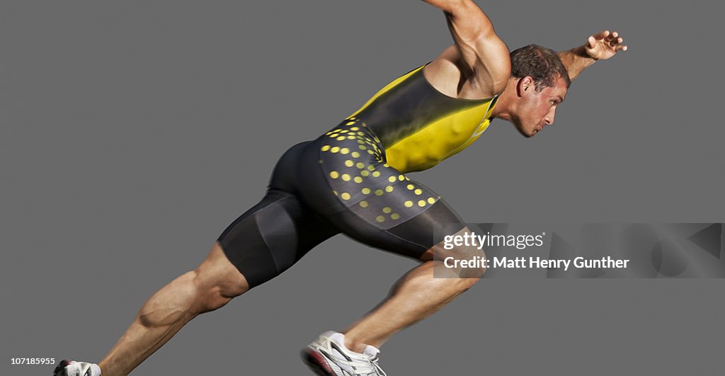 Male sprinter taking off from starting blocks
