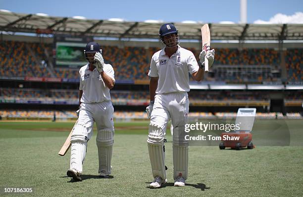 Jonathan Trott of England leaves the field after making a century and Alastair Cook of England after reaching his double century during day five of...