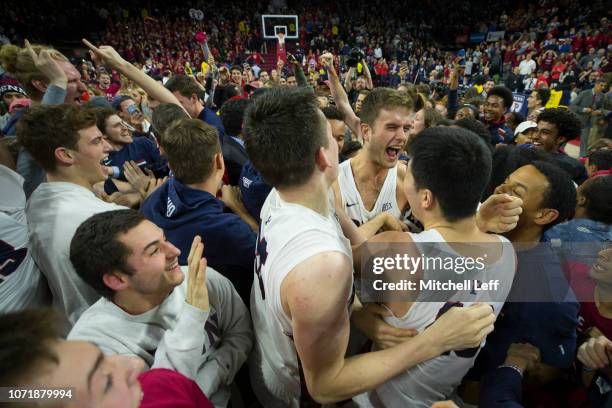 Max Rothschild, AJ Brodeur, and Michael Wang of the Pennsylvania Quakers celebrate their win over the Villanova Wildcats at The Palestra on December...