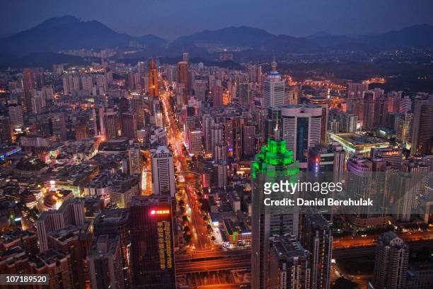 The Shenzhen skyline, including The Shenzhen World Financial Center, illuminated by green lights, stretches in to the distance on November 28, 2010...
