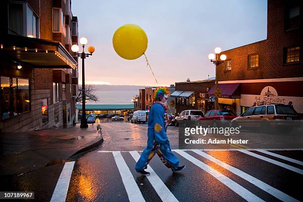 a young girl dressed up as a clown walking. - joker stock pictures, royalty-free photos & images