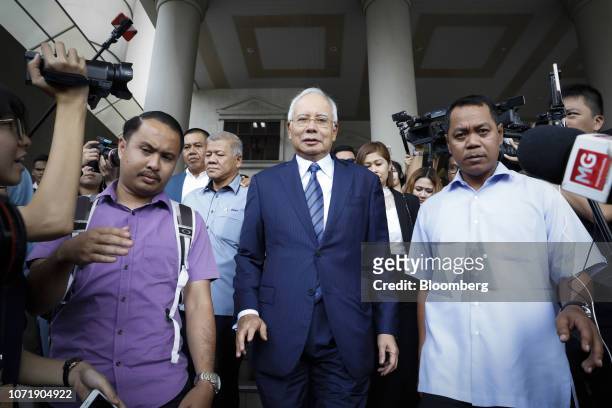 Najib Razak, Malaysia's former prime minister, center, leaves the Kuala Lumpur Courts Complex in Kuala Lumpur, Malaysia, on Wednesday, Dec. 12,...