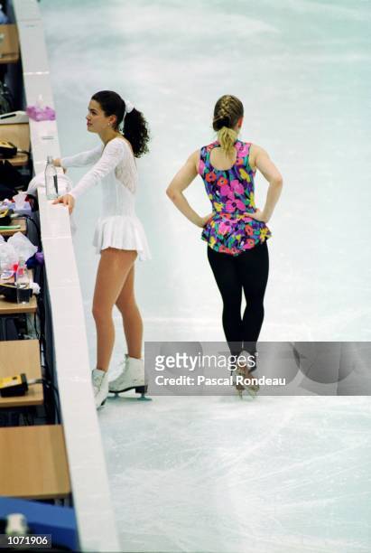 Nancy Kerrigan of the USA and Tonya Harding of the USA pass each other without speaking or looking at one another during a training session held at...