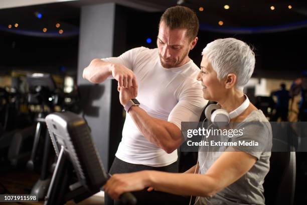 active senior woman and a fitness instructor - peloton app stock pictures, royalty-free photos & images