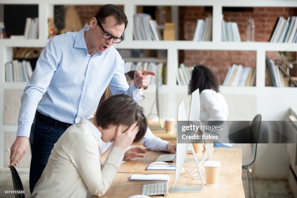 Furious male employee scream at worker blaming for mistake