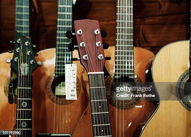 different classic guitars in a shop - guitar shop stock pictures, royalty-free photos & images