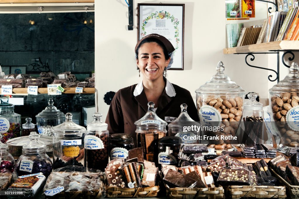 Woman selling chocolate in a chocolare shop