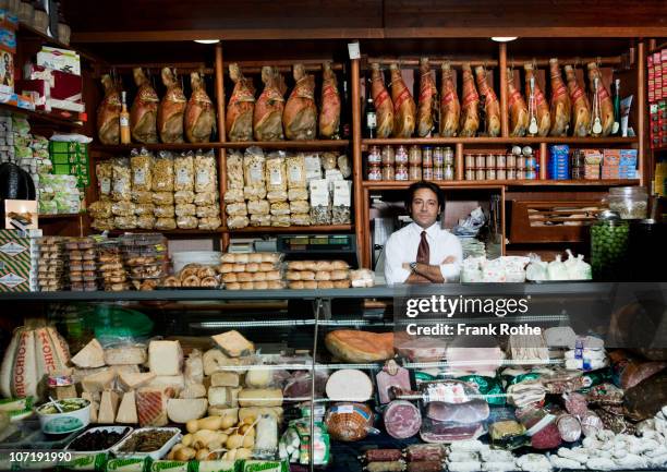 a grocer behind his counter in his shop - italy food stock pictures, royalty-free photos & images