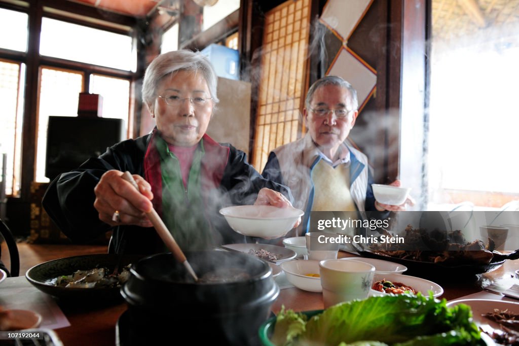 Grandmother serving Soup