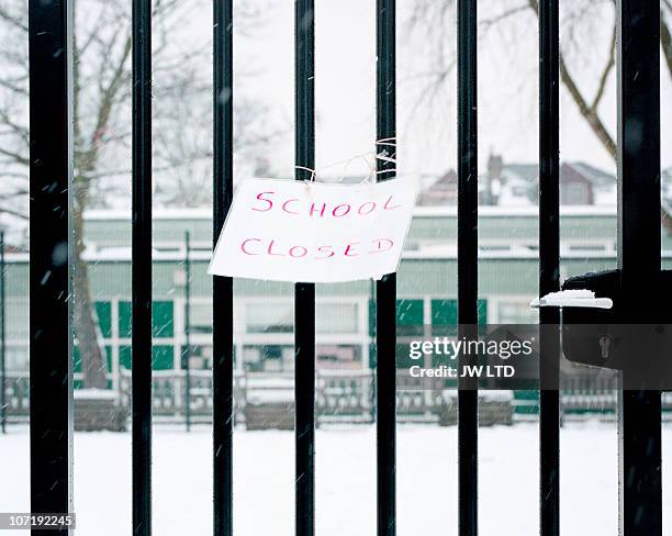 sign on railings saying school closed - snow uk stock pictures, royalty-free photos & images