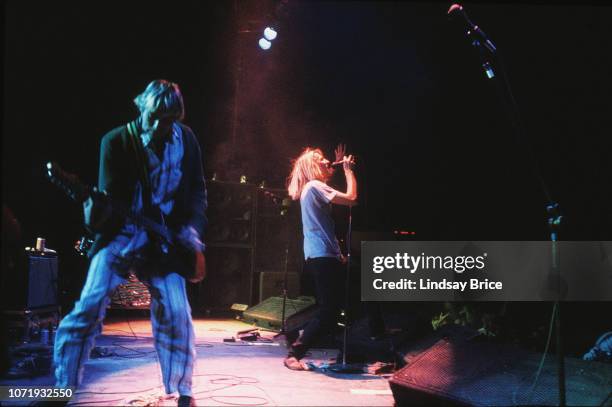 Kurt Cobain, dressed in striped pajamas and a green cardigan, joins Mudhoney on stage with guitar, Mark Arm at the mic, at concert featuring...